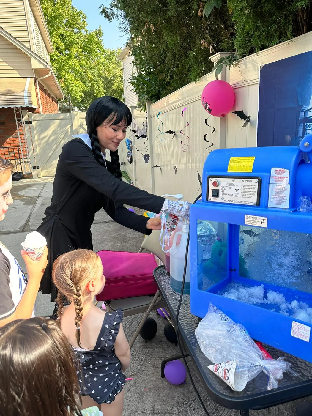 A performer serving a frozen treat at a party